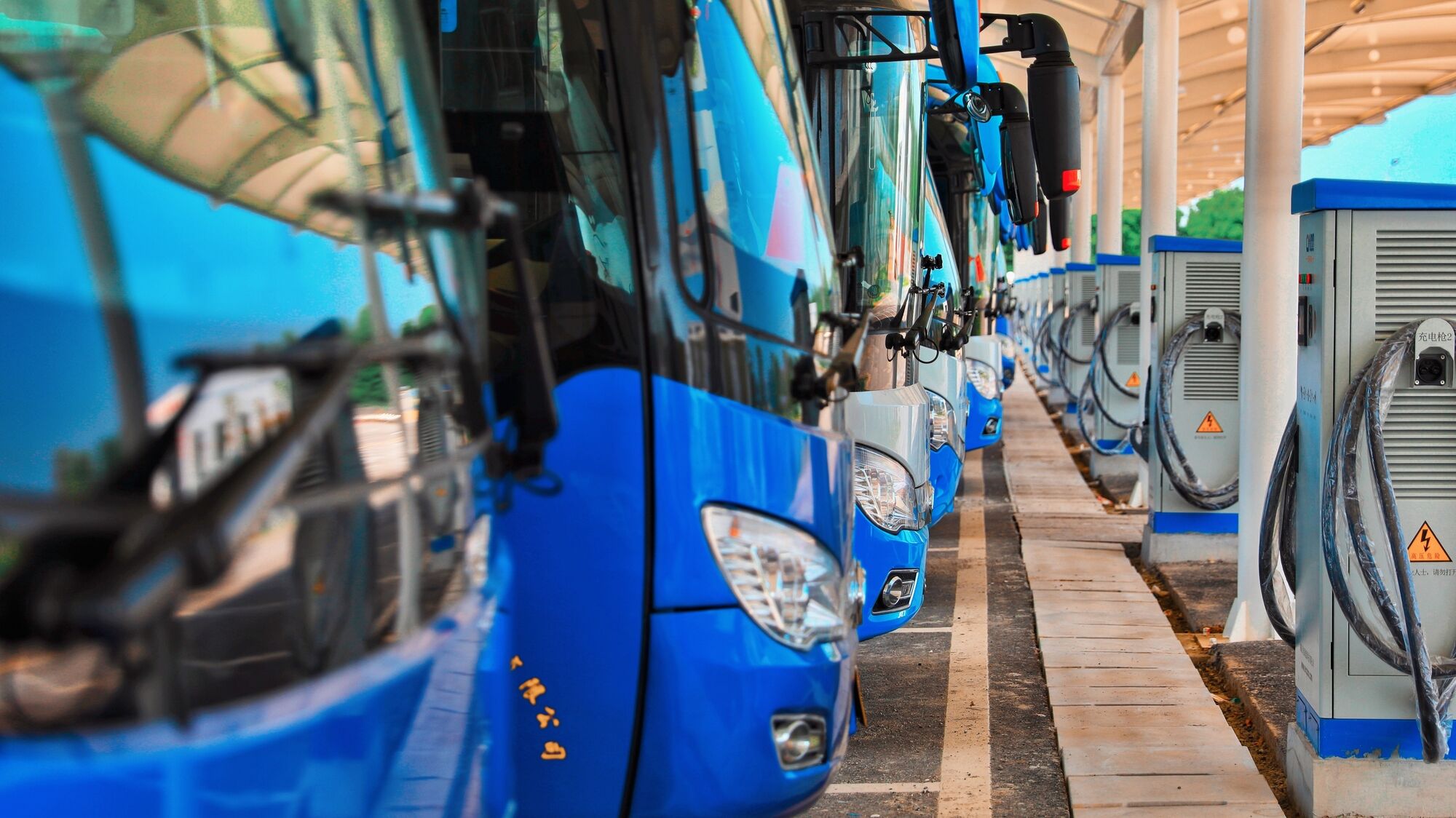 Fleet of buses next to charging stations
