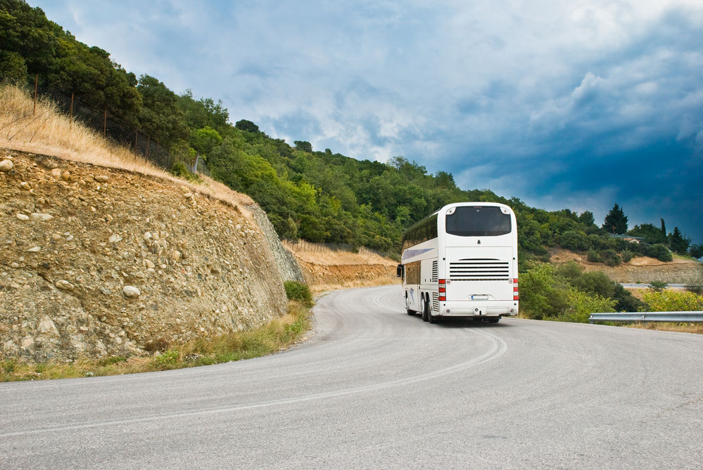 The modern tourist bus on mountain road